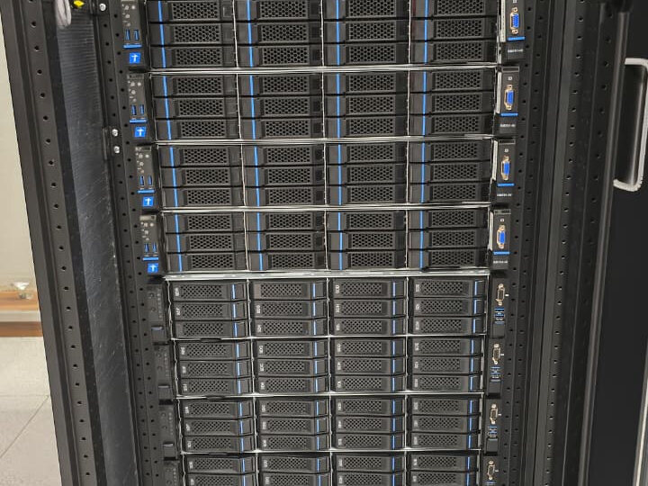 Front view of a rack column densely filled with stacked rack-mounted servers